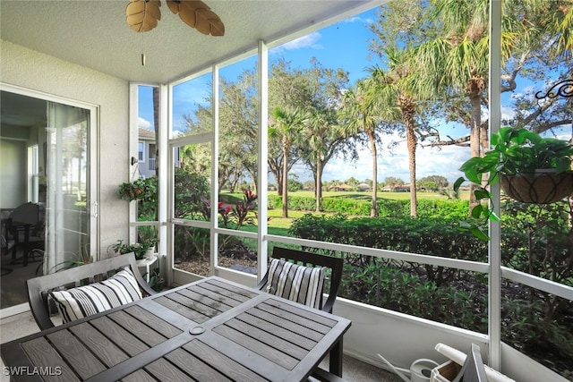 sunroom featuring ceiling fan