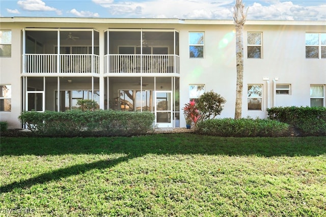 rear view of house featuring a yard