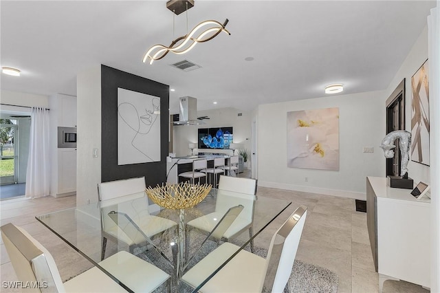 dining room featuring light tile patterned floors and ceiling fan with notable chandelier