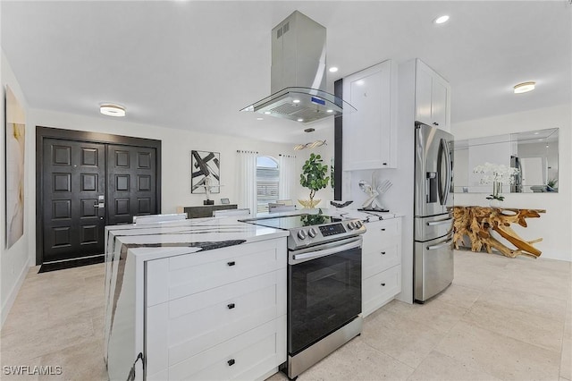 kitchen with white cabinetry, light stone counters, island range hood, and appliances with stainless steel finishes