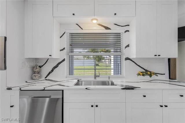 kitchen featuring sink, dishwasher, white cabinets, and light stone countertops