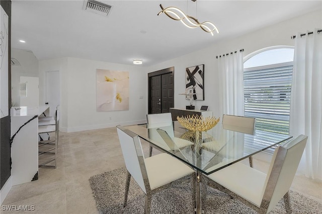 dining room with a notable chandelier and plenty of natural light