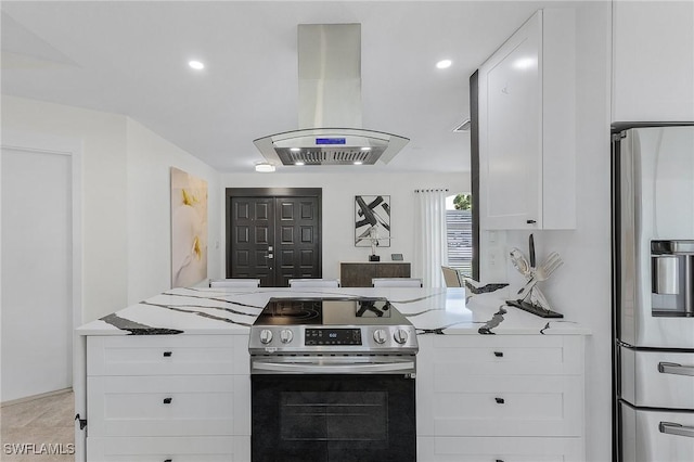 kitchen featuring island exhaust hood, stainless steel appliances, kitchen peninsula, and white cabinets