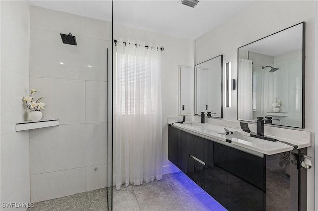 bathroom featuring walk in shower, tile patterned floors, and vanity