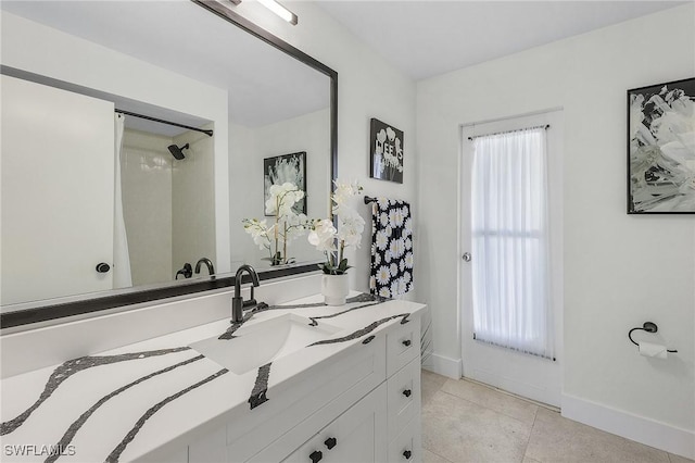 bathroom with vanity, tile patterned flooring, and a shower