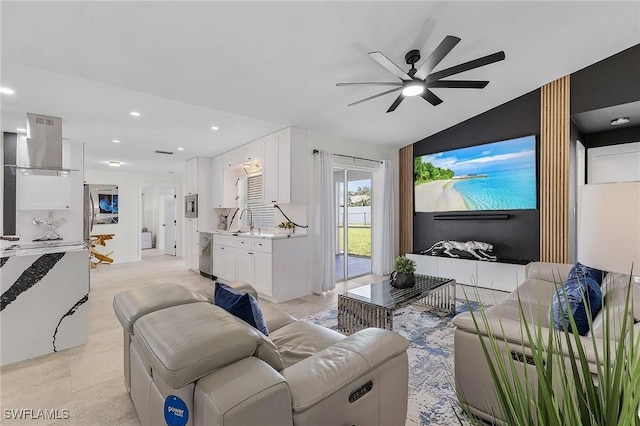 tiled living room featuring ceiling fan, sink, and vaulted ceiling