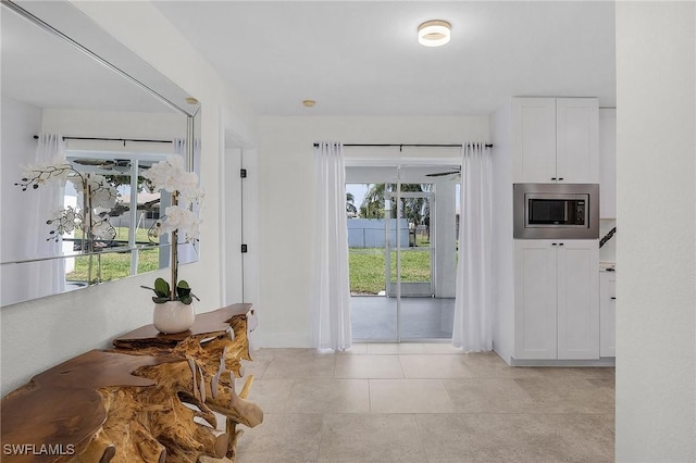 doorway featuring light tile patterned flooring