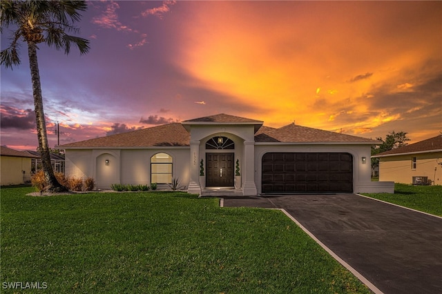 mediterranean / spanish house featuring a yard and a garage