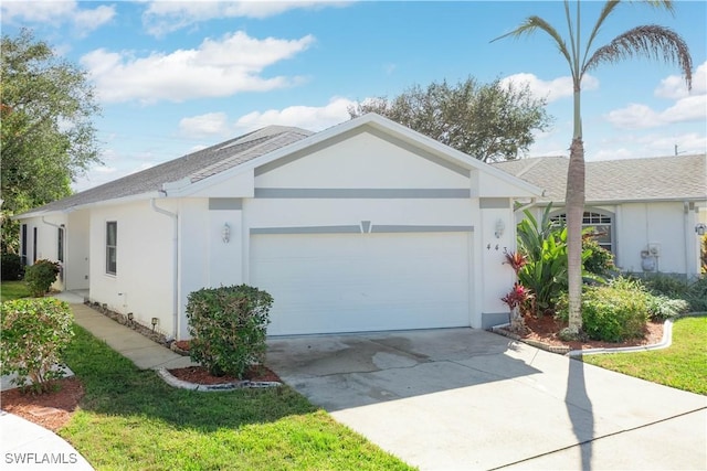 ranch-style house featuring a garage, driveway, and stucco siding