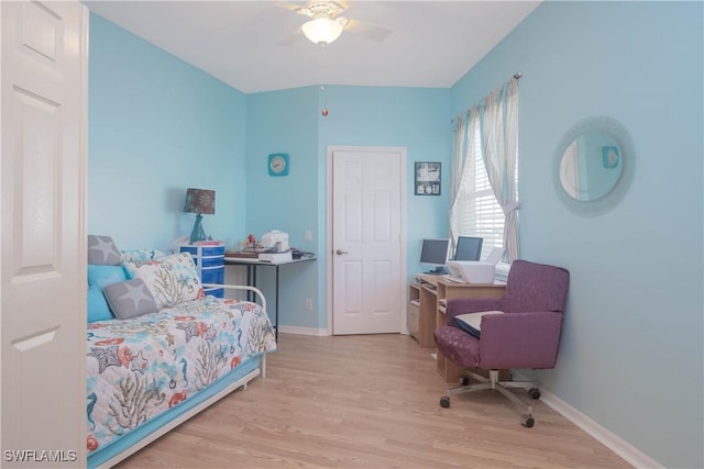 bedroom with wood finished floors, a ceiling fan, and baseboards