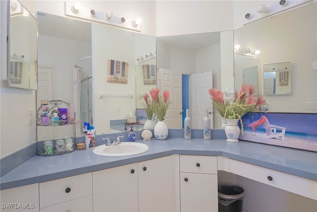 bathroom with a shower and vanity