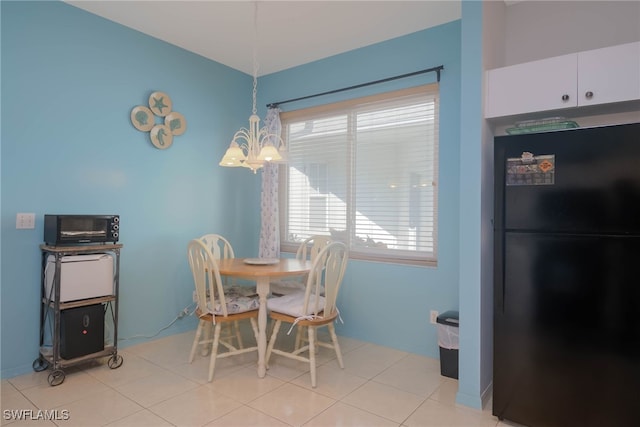 dining room with a chandelier and light tile patterned flooring