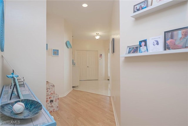 corridor with recessed lighting, wood finished floors, and baseboards