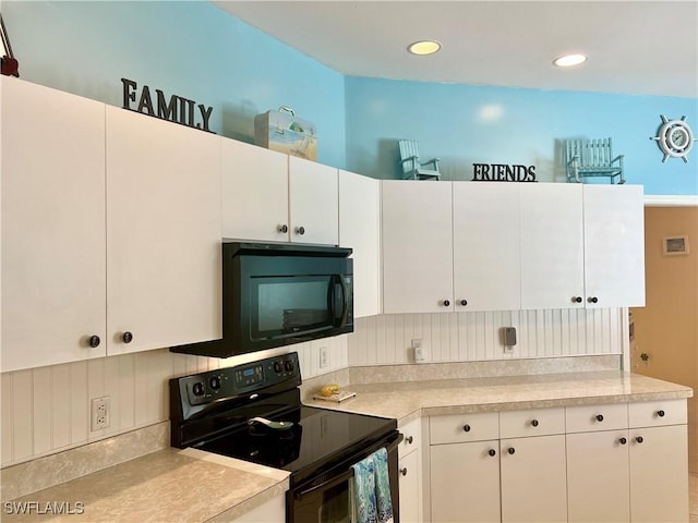 kitchen with white cabinets, black appliances, light countertops, and recessed lighting