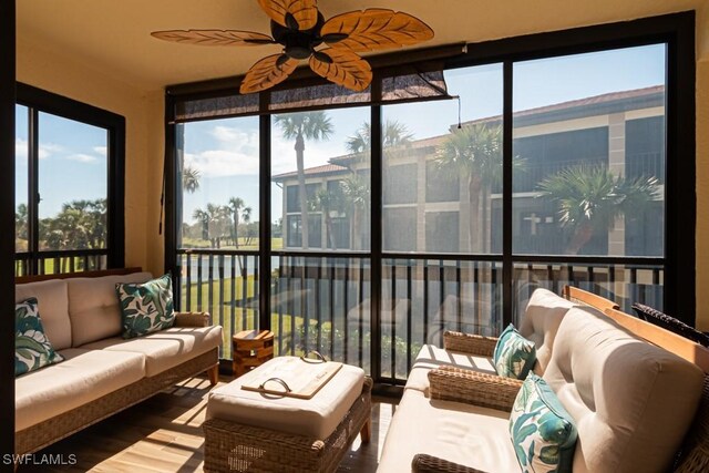 sunroom featuring ceiling fan