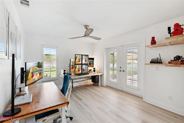 home office with plenty of natural light, light hardwood / wood-style floors, french doors, and ceiling fan