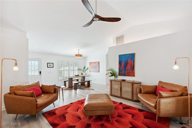 living room with vaulted ceiling, light hardwood / wood-style floors, and ceiling fan