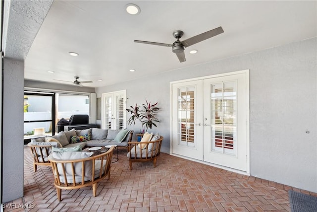 living room with ceiling fan and french doors