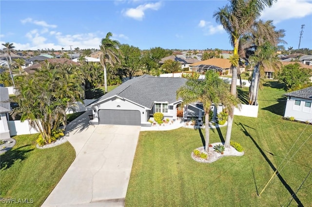 view of front of house featuring a garage and a front lawn