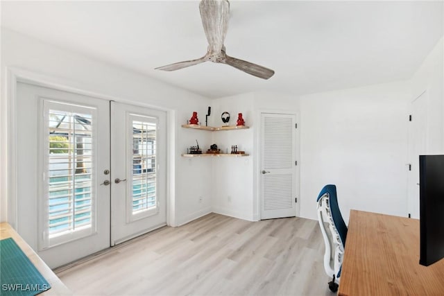 unfurnished office with ceiling fan, light wood-type flooring, and french doors