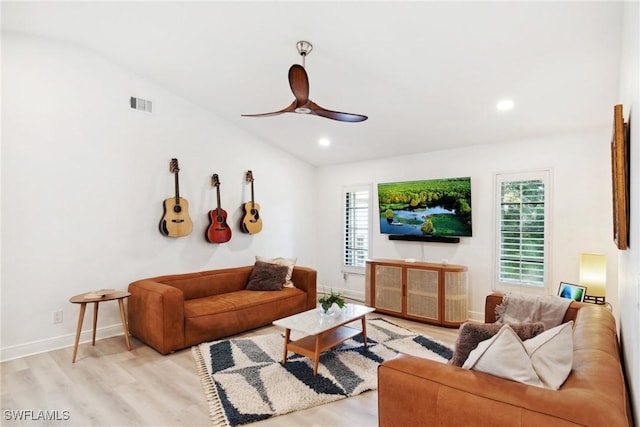 living room featuring vaulted ceiling, ceiling fan, and light hardwood / wood-style floors