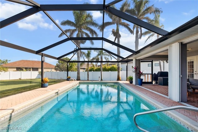 view of swimming pool featuring a lanai and a patio area