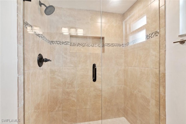 bathroom featuring a shower with shower door