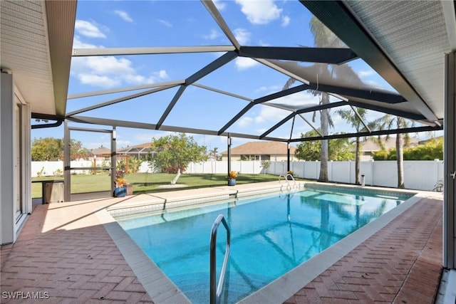 view of pool featuring glass enclosure and a patio area