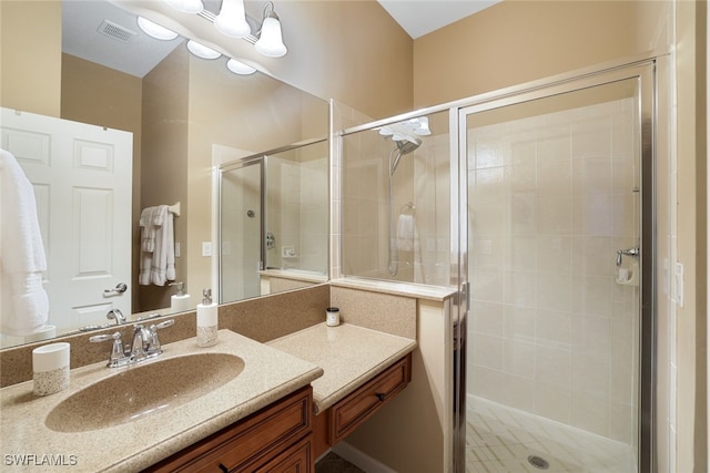 bathroom featuring vanity and a shower with door