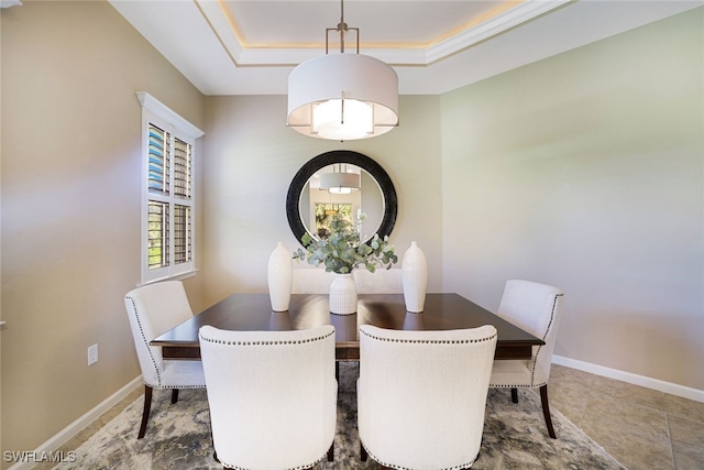 dining room with a raised ceiling