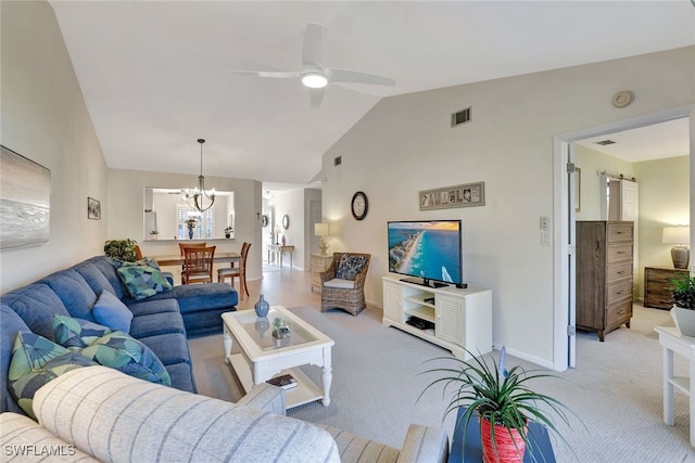 living room featuring light colored carpet, lofted ceiling, and ceiling fan with notable chandelier