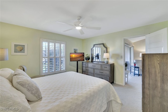 bedroom featuring light carpet and ceiling fan