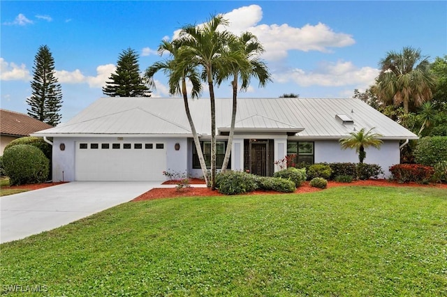 view of front of house with a garage and a front lawn