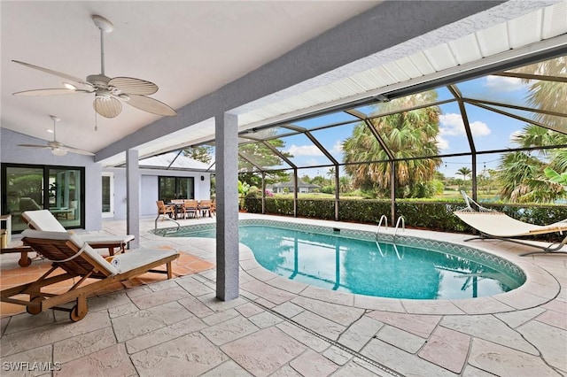 view of swimming pool with ceiling fan, a lanai, and a patio area