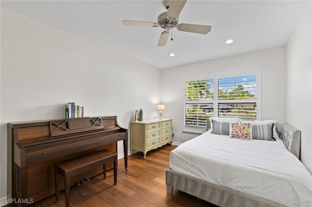 bedroom with ceiling fan and dark hardwood / wood-style floors