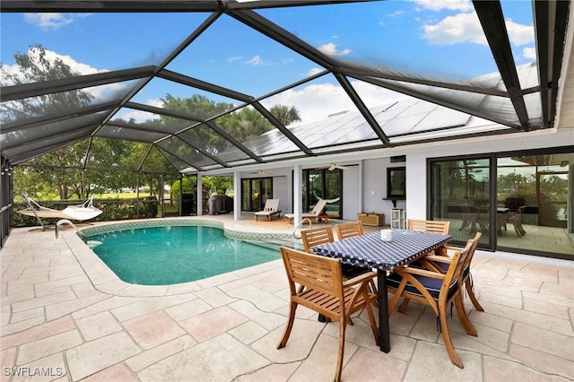 view of swimming pool with a lanai and a patio area