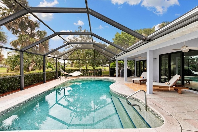 view of swimming pool featuring a lanai, ceiling fan, and a patio area