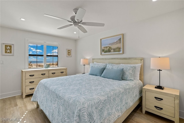 bedroom featuring ceiling fan and light hardwood / wood-style floors