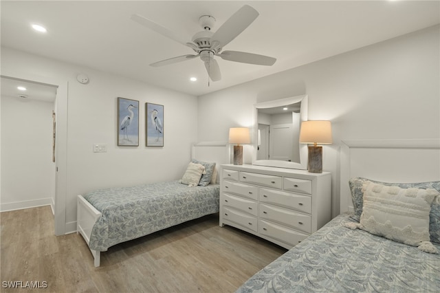 bedroom with light hardwood / wood-style flooring and ceiling fan