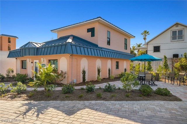 back of house with a patio