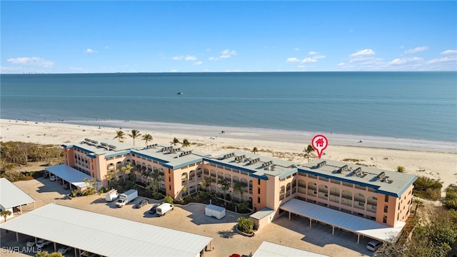 birds eye view of property featuring a beach view and a water view