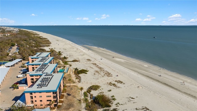 drone / aerial view with a water view and a beach view