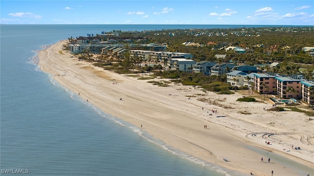 drone / aerial view featuring a water view and a beach view