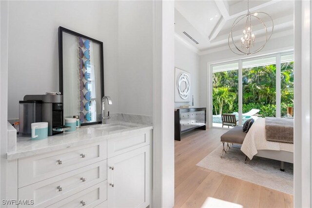 bedroom with sink, a chandelier, coffered ceiling, access to exterior, and light hardwood / wood-style flooring