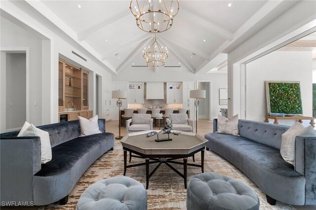 living room with an inviting chandelier, high vaulted ceiling, sink, light hardwood / wood-style floors, and beam ceiling