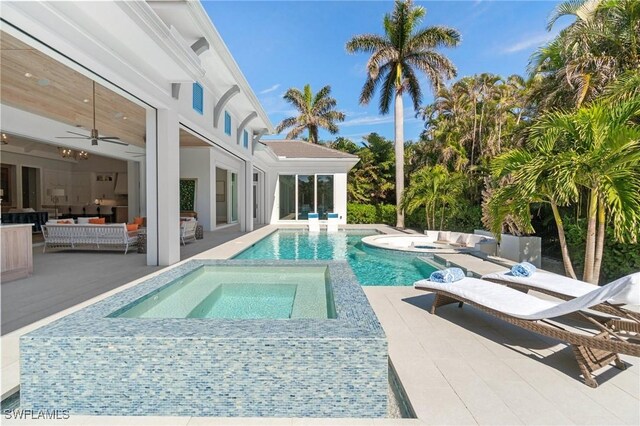 view of swimming pool with an in ground hot tub, ceiling fan, outdoor lounge area, and a patio