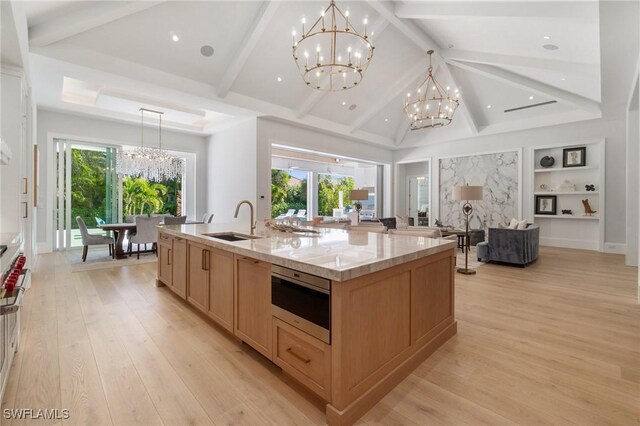 kitchen featuring a notable chandelier, sink, hanging light fixtures, and a spacious island