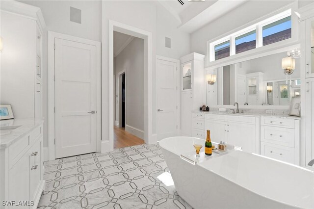 bathroom featuring a washtub and vanity