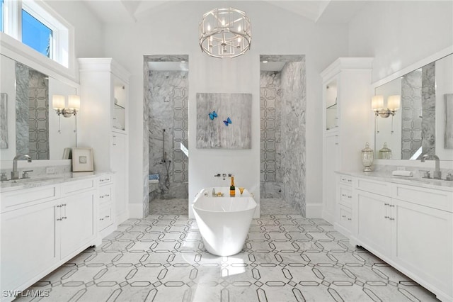 bathroom featuring a notable chandelier, a freestanding bath, a sink, and tiled shower