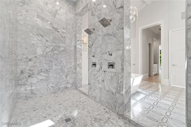 bathroom featuring a marble finish shower and baseboards